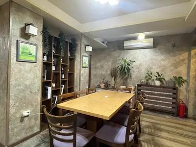 a dining room with a wooden table and chairs at Mineral 56 in Banya