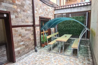 a patio with a table and an umbrella at Apartment with veranda in Bansko