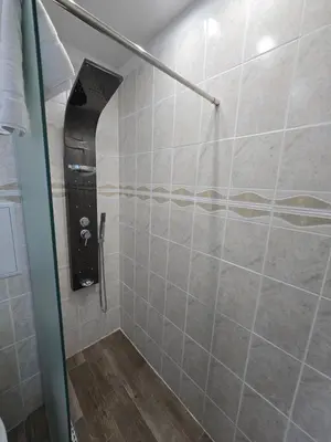 a shower with a glass door in a bathroom at Apartment with veranda in Bansko