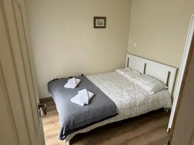 a bedroom with a bed with two pillows on it at Simple and Affordable Apartment in Bansko with available parking space in Bansko