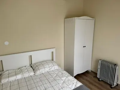 a bedroom with a bed and a white cabinet at Simple and Affordable Apartment in Bansko with available parking space in Bansko