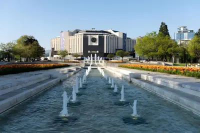 a fountain in a park in front of a building at Central Apartment 2 in Sofia