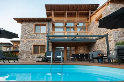 a house with a swimming pool in front of a house at Aqua Thermal Villa Banya in Banya