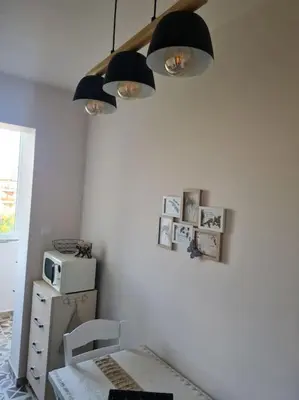 a room with a table and two lights on the wall at Домът на Билкарката in Plovdiv
