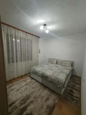 a bedroom with a bed in the corner of a room at Levkov in Petrich