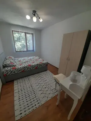 a bedroom with a bed and a table in it at Levkov in Petrich