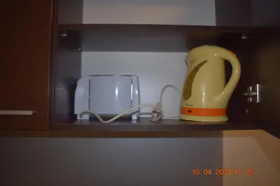 a yellow jug sitting on a shelf next to a appliance at Villa Park Guest Apartments in Borovets