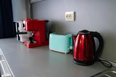 a kitchen counter with a tea kettle and a toaster at 7 Seconds Away From the Main Street, FREE Parking in Sofia