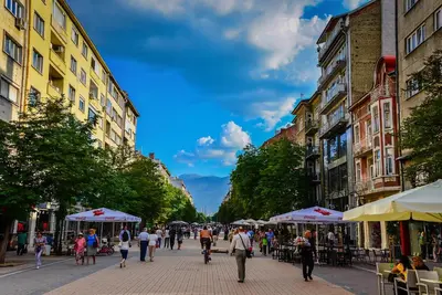 a group of people walking down a city street at 7 Seconds Away From the Main Street, FREE Parking in Sofia