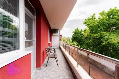a balcony with a chair and a window at Апартамент Веирас 2 in Velingrad