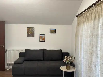a living room with a couch and a table at Вила Белият камък - Златоград in Zlatograd