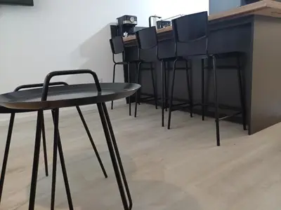 a group of black chairs sitting at a bar at Apartament-DEMIAN in Sofia