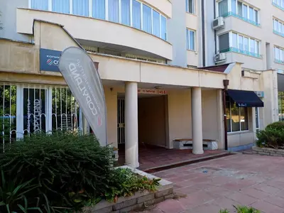 a building with a sign in front of it at Apartament-DEMIAN in Sofia
