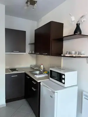 a small kitchen with a microwave and a refrigerator at B7 Luxury Studio Apartment in Green Life Bansko in Bansko