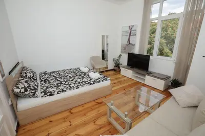 a bedroom with a bed and a television in it at Уютна къща в сърцето на София in Sofia