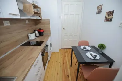 a small kitchen with a table and a counter top at Уютна къща в сърцето на София in Sofia