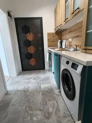 a washing machine in a kitchen with a door at Apartament Aleksandar Premium in Kyustendil