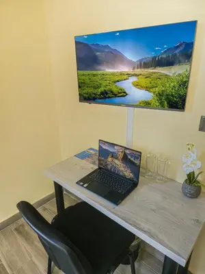 a desk with a laptop computer on a table at Хостел Стадиона in Pazardzhik