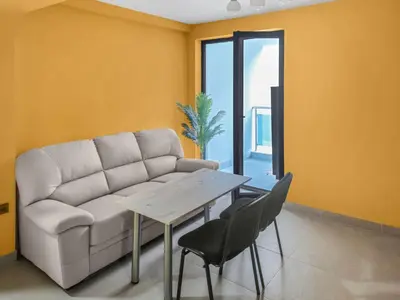 a living room with a couch and a table at Хостел Стадиона in Pazardzhik