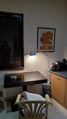 a desk with a lamp and a chair in a room at Apartments in Ramada 2 Complex in Bansko