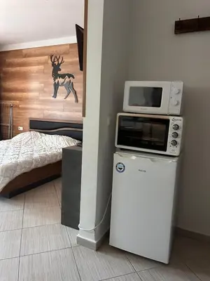 a kitchen with a microwave on top of a refrigerator at B8 Luxury Studio Apartment in Green Life Bansko in Bansko