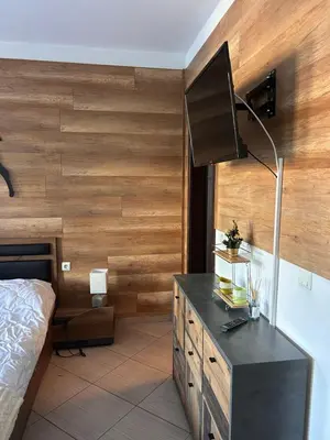 a bedroom with a bed and a desk with a lamp at B8 Luxury Studio Apartment in Green Life Bansko in Bansko