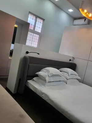 a bed with white pillows in a room with a window at La Maison des Fleurs FREE PARKING in Pazardzhik