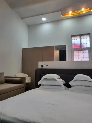 a bedroom with a bed and a couch at La Maison des Fleurs FREE PARKING in Pazardzhik