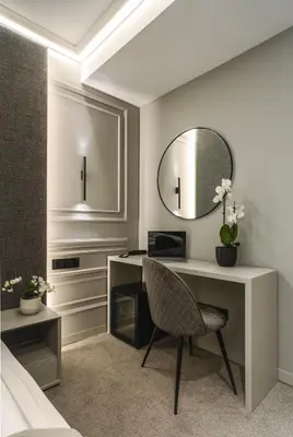 a bedroom with a desk and a mirror at Sentro Boutique Hotel in Sofia