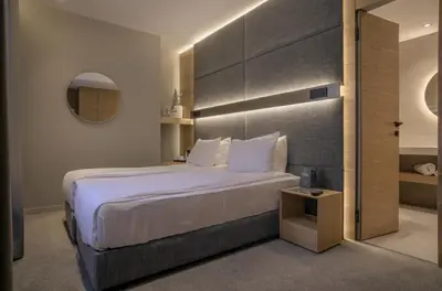 a bedroom with a large bed and a table at Sentro Boutique Hotel in Sofia