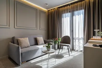 a living room with a couch and a table at Sentro Boutique Hotel in Sofia
