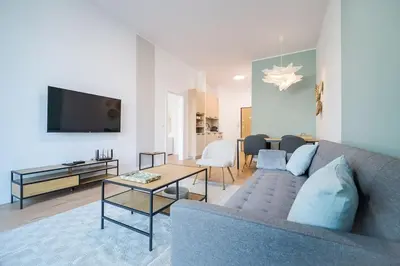 a living room with a couch and a tv at Mycampus 1 bdrm, stay 4, free parking, garden, self check-in in Sofia
