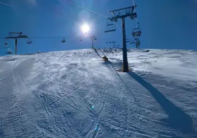 a ski lift on top of a snow covered slope at Mountain View Apartment with Balcony & Ski Access nearby - Serendipity in Bansko