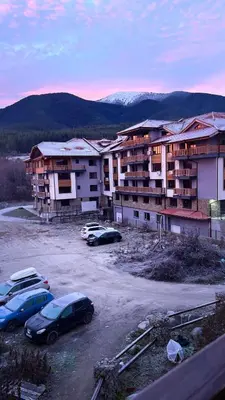 a group of cars parked in a parking lot at Mountain View Apartment with Balcony & Ski Access nearby - Serendipity in Bansko