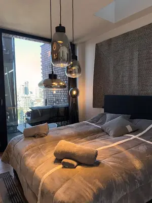 a bedroom with a large bed with two towels on it at Sofia Rooftop Red Apple in Sofia