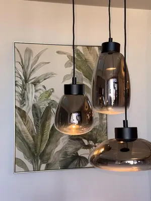 three glass lights hanging from a wall with a painting at Sofia Rooftop Red Apple in Sofia