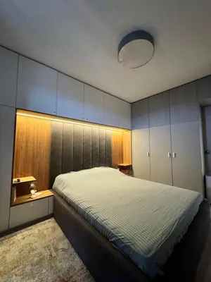 a bedroom with a large bed and a large cabinet at Central Apartment with Amazing Views in Sofia