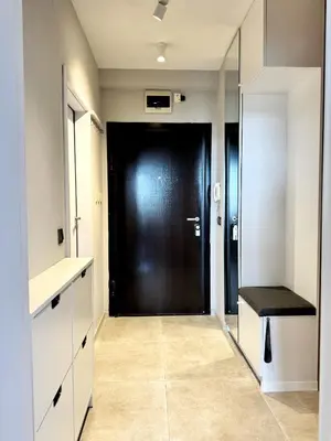 a hallway with a black door and a black bench at Central Apartment with Amazing Views in Sofia