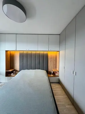 a bedroom with a large white bed and a desk at Central Apartment with Amazing Views in Sofia