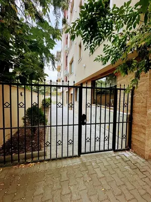 a black gate in front of a building at Grace Appartament in Plovdiv