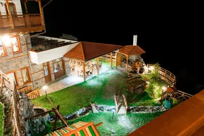 an aerial view of a house with a swimming pool at night at Hotel Mursal in Yagodina