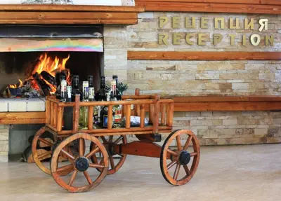 a wooden cart full of beer bottles in front of a fireplace at Hotel Mursal in Yagodina
