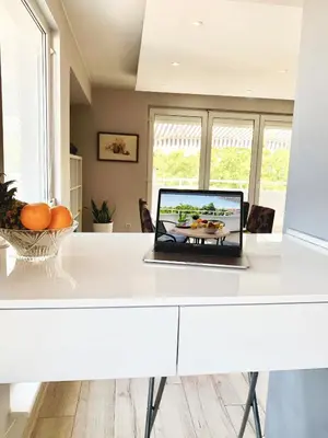 a laptop computer sitting on a white desk at Bellevue Appart Centrum in Plovdiv