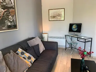 a living room with a couch and a table at Bellevue Appart Centrum in Plovdiv