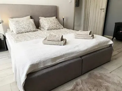 a large bed with two towels on top of it at Bellevue Appart Centrum in Plovdiv