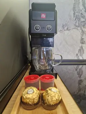 a coffee maker with two donuts on a table at Daisy Garden by the Church in Razlog