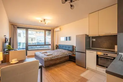 a kitchen and a bedroom with a bed in a room at Palitra Studio in Sofia