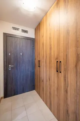 a large wooden door in a room with a tile floor at Palitra Studio in Sofia