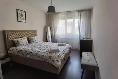 a bedroom with a bed and a window at Family Suite in Sofia