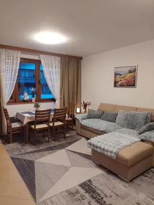 a living room with a bed and a dining room at Bansko Pirin Golf & Country Club Blue Mountains View in Razlog